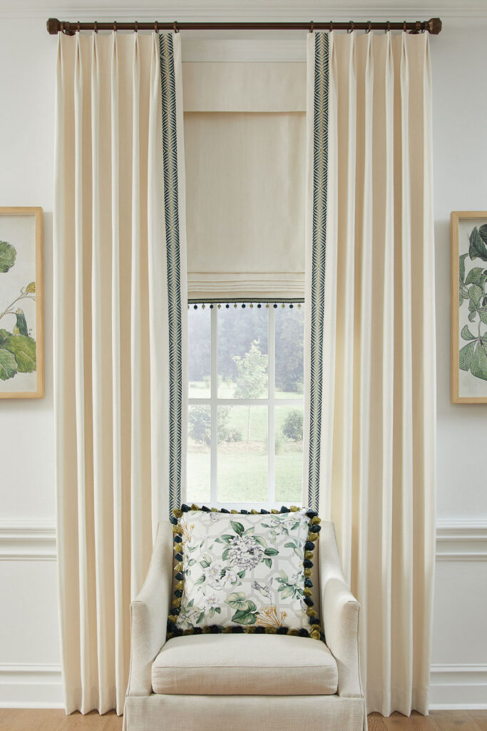 Olivia Pleat Drapery with vertical trim over a Flat Roman Shade with horizontal trim.