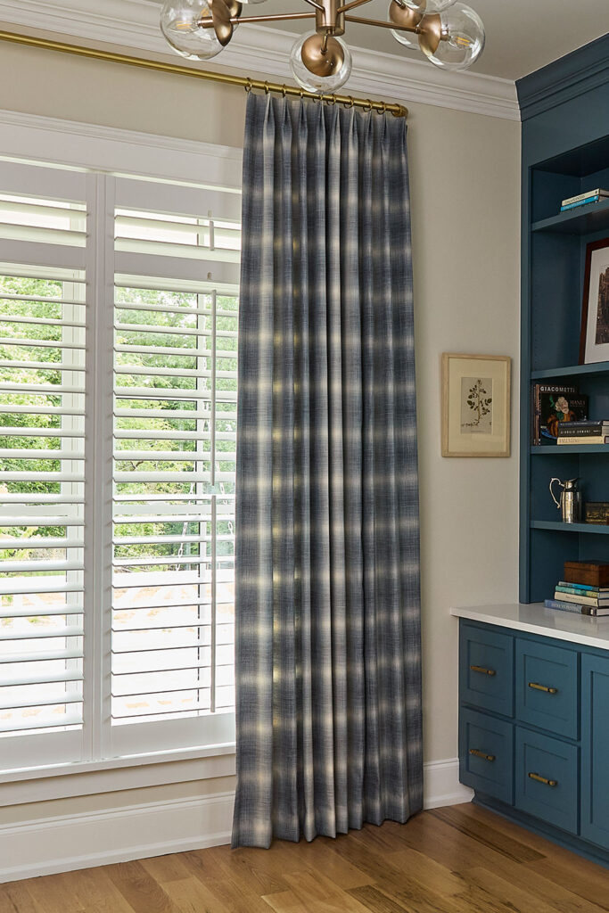 Olivia Pleat Drapery in a large scale blue and off-white plaid on an office window.