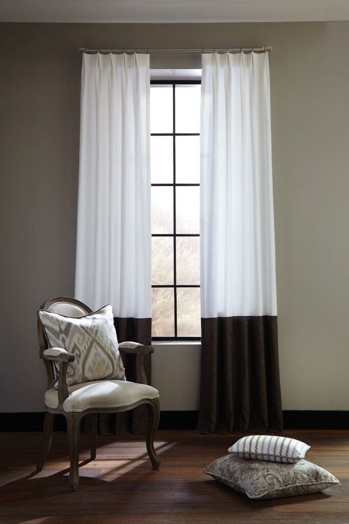 Olivia Pleat Drapery in Stria Style with white on the top and dark brown on the bottom.