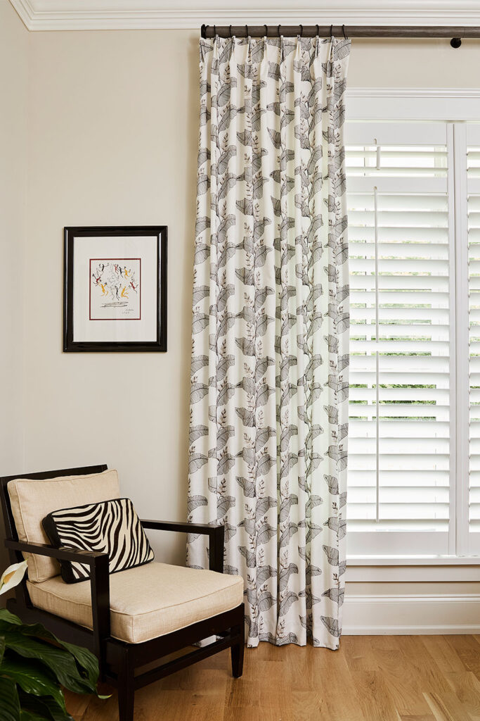 Olivia Pleat Drapery in a black and white leaf pattern for a guest bedroom.