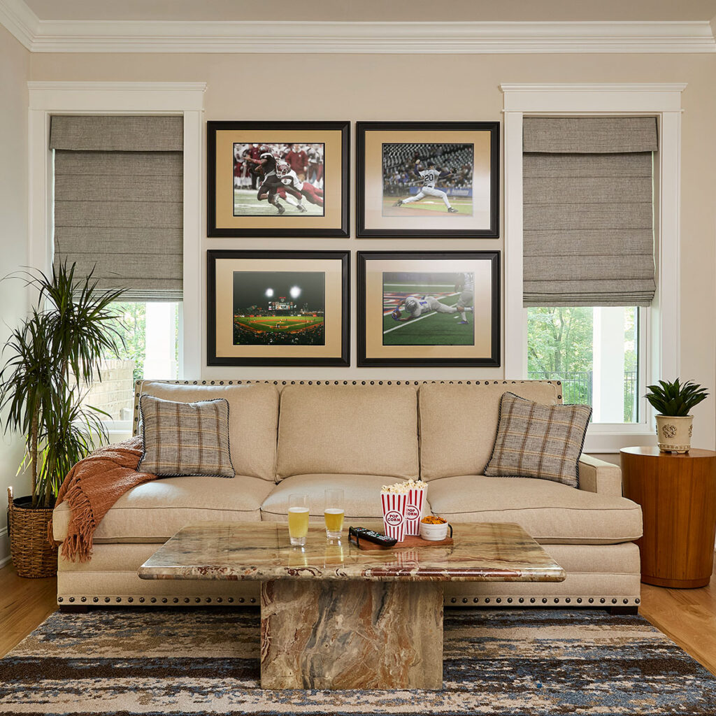 A media room with Reverse Fold Roman Shades, positioned off the back and featuring blackout lining for the ultimate movie viewing experience.