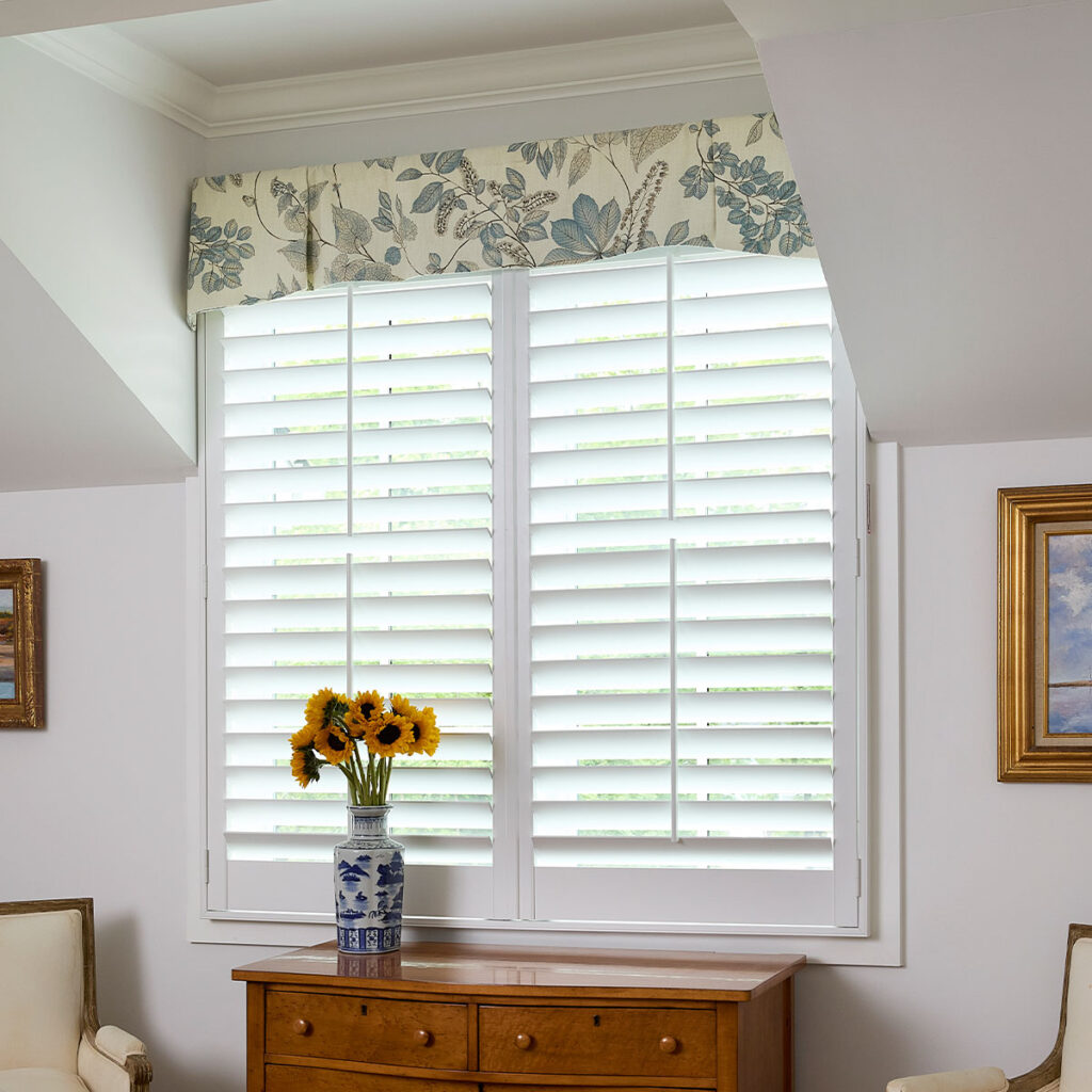 A Briscoe Rod Mounted Valance in the dormer window of a traditionally styles guest room.