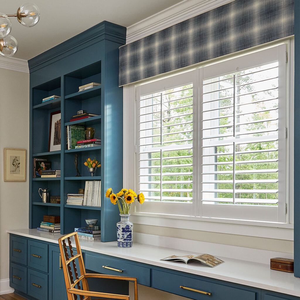 An office windows with a Statler Cornice in a large-scale blue and ivory plaid fabric.