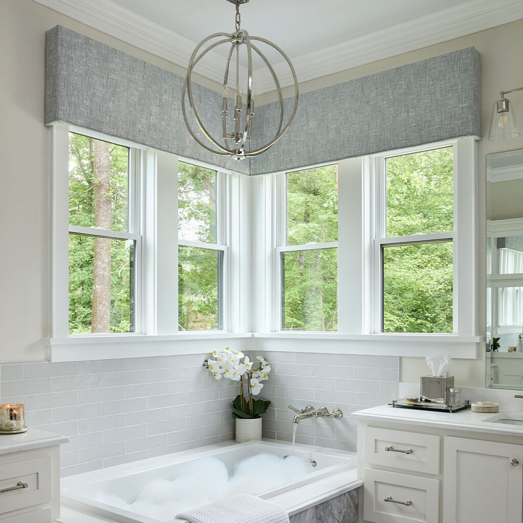 Statler Cornices on corner windows above a bathtub.