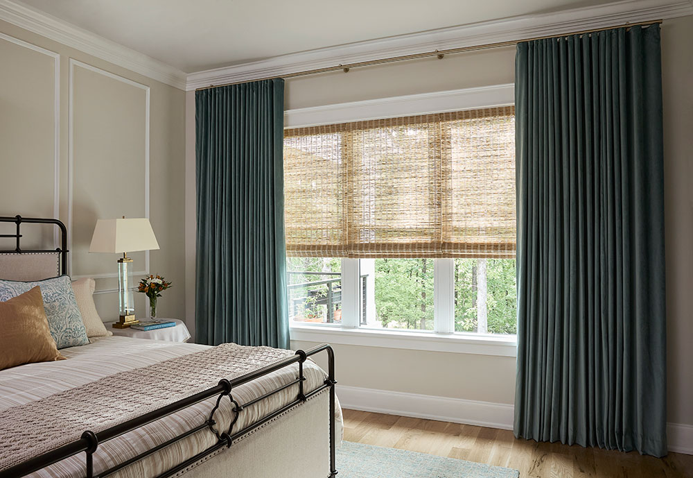 Primary bedroom featuring dark green velvet Carole Fabrics Ripplefold Drapery on Forest Dresden Motorized Hardware in Satin Brass with PowerView Automation.