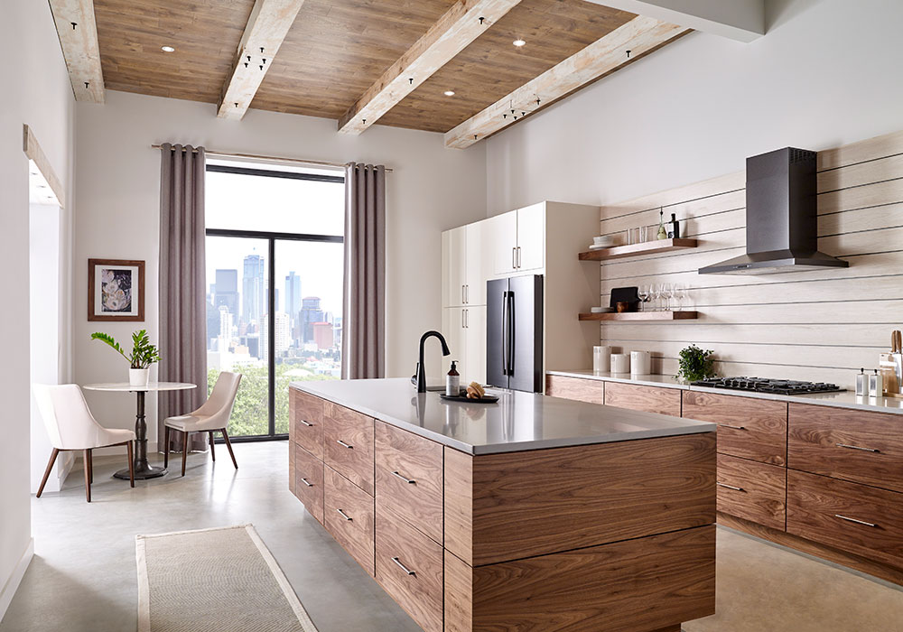 A modern open kitchen with draperies on Kirsch drapery hardware over a floor to ceiling window on the far end of the room.