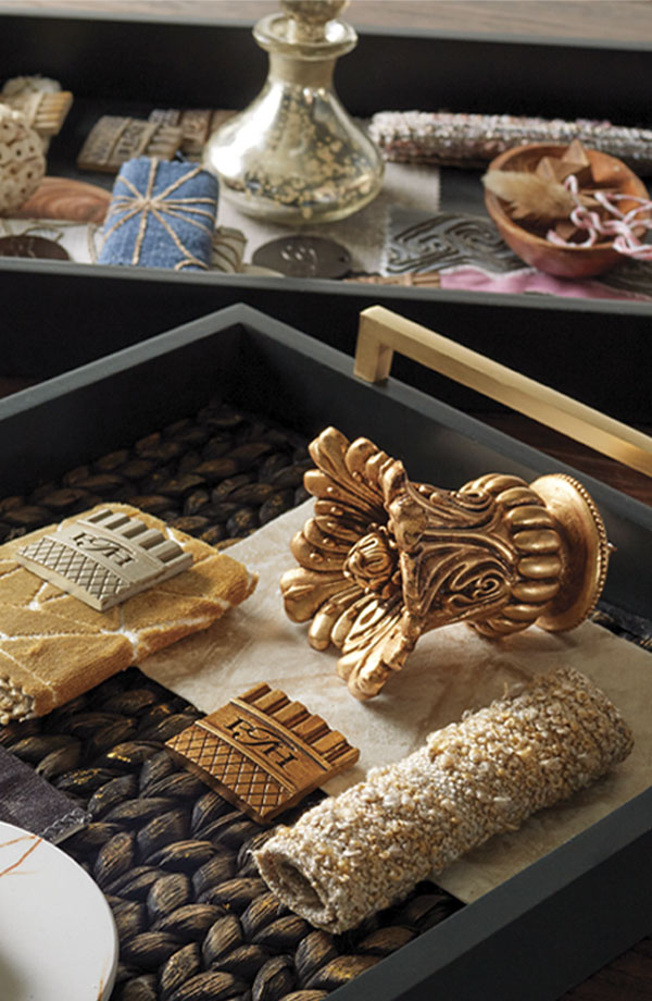 Detail of fabrics and Paris Texas Hardware finials and finish chips in black trays to create mood boards.