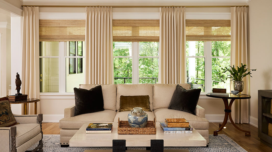 A living room in rich cream colors and golden accents.