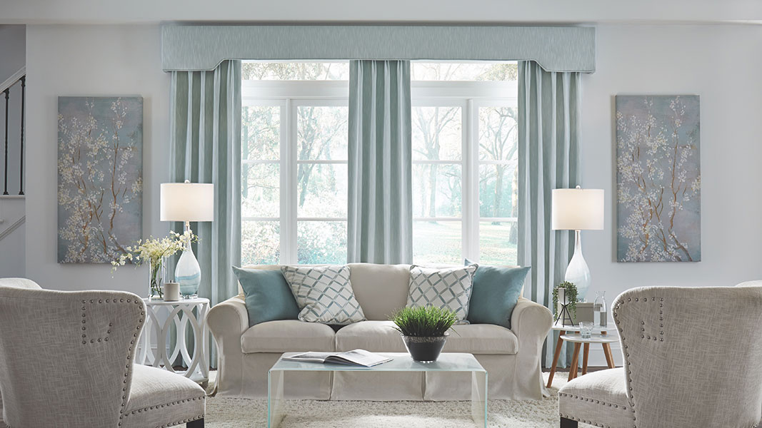 A living room in light neutrals and a hint of light blue.