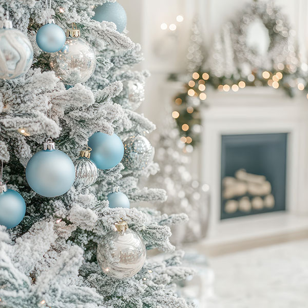 A white room with accents of greenery and light blue create a winter wonderland.